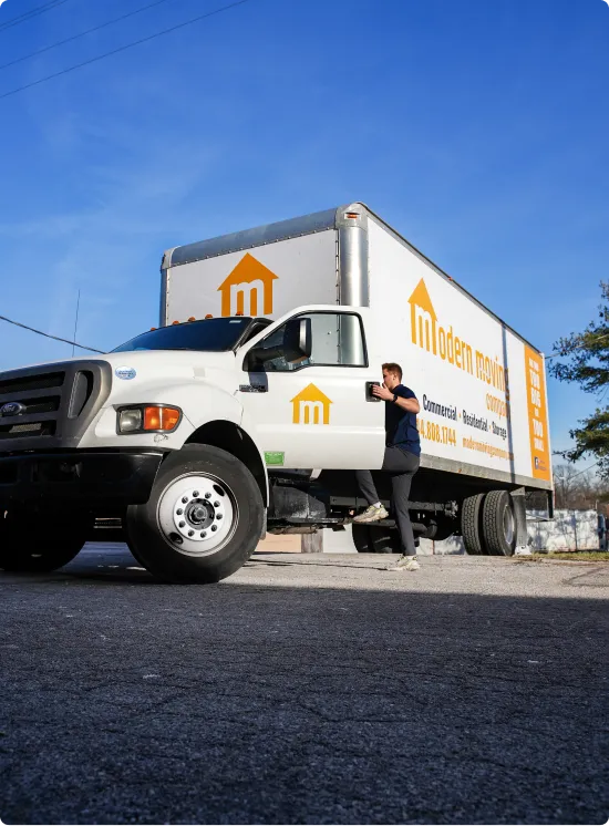 Person moving boxes on dolly